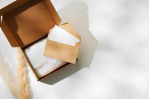 Delivery package with a blank envelope and decorative elements on a light background photo