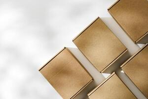 Brown cardboard boxes arranged on a neutral background in a warehouse setting during daylight hours photo