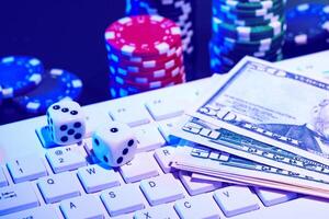 Game chips and cash on a dimly lit keyboard during an exciting gaming night at home photo