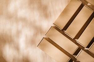Brown cardboard boxes arranged on a neutral background in a warehouse setting during daylight hours photo