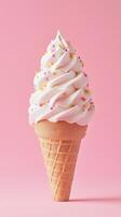 Delicious soft serve ice cream cone topped with colorful sprinkles placed against a pink background during a sunny day photo