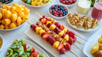 Colorful fruit skewers surrounded by an array of fresh fruits on a table at a summer gathering photo