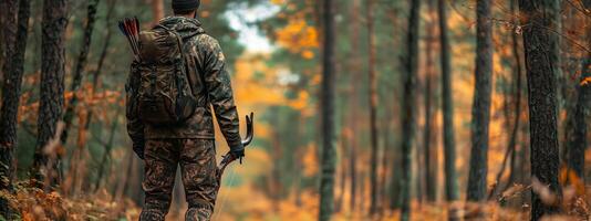 A hunter walks through an autumn forest with a bow and arrows, surrounded by colorful foliage under a cloudy sky photo