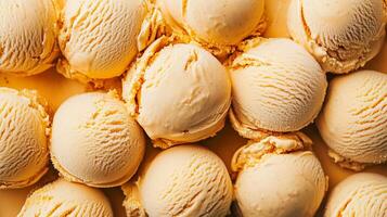 Creamy vanilla ice cream scoops arranged on a bright yellow background for a delightful dessert display photo