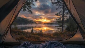 Sunrise view from a camping tent by a tranquil lake surrounded by lush forests during a peaceful morning photo
