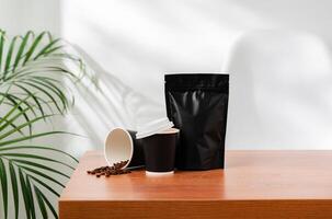 Three beverage containers and a paper bag on a wooden table photo