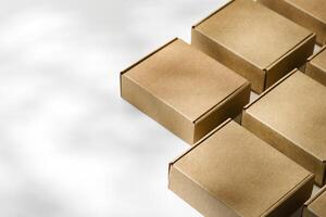 Brown cardboard boxes arranged on a neutral background in a warehouse setting during daylight hours photo
