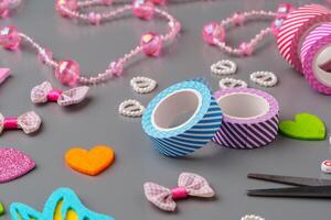 Crafting materials and tools arranged on a gray surface during a creative project photo
