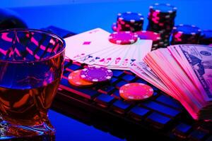 Game chips and cash on a dimly lit keyboard during an exciting gaming night at home photo