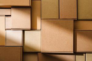Stacked cardboard boxes arranged in a neat pattern under natural light photo