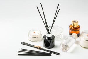 Aromatic essentials including scented candles, incense sticks, and diffusers arranged on a light background photo