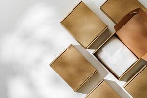 Brown cardboard boxes arranged on a neutral background in a warehouse setting during daylight hours photo