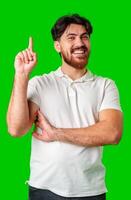 Man with a beard smiling and raising finger in a bright green studio photo