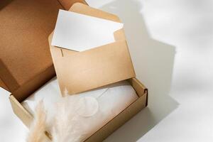 Delivery package with a blank envelope and decorative elements on a light background photo
