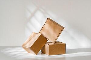 Freshly packed cardboard boxes resting on a white surface, illuminated by soft natural light photo