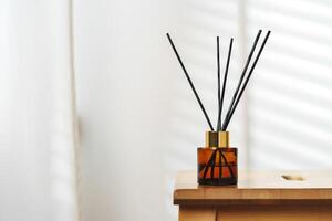 Elegant Reed Diffusers on Wooden Surface With Soft Background Light photo