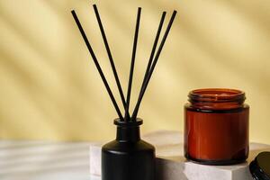 Elegant Reed Diffuser and Scented Candle on a Modern Desk at Golden Hour photo