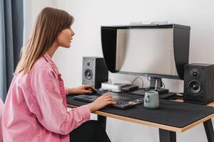 Handsome, smiling woman, freelancer, copywriter working, using computer, typing keyboard photo