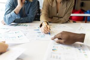 Marketing team analyzing financial data with charts and graphs photo