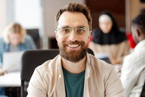 Manager smiling at camera working in busy diverse office startup company meeting photo