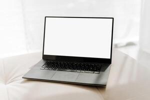 Modern laptop showing empty screen displaying white background photo