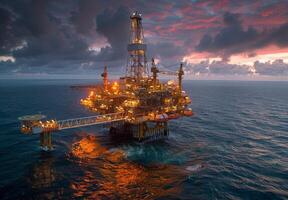 Panoramic view of an offshore oil rig illuminated by the setting sun, surrounded by the vast expanse of the ocean photo