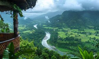 A panoramic view of a winding river through a lush valley, seen from a balcony of a highland retreat photo
