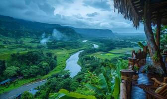 A panoramic view of a winding river through a lush valley, seen from a balcony of a highland retreat photo