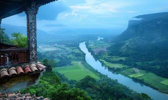 A panoramic view of a winding river through a lush valley, seen from a balcony of a highland retreat photo