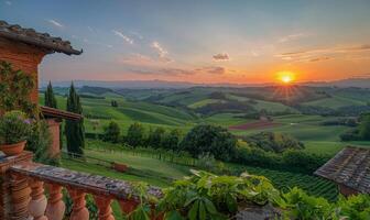 A panoramic view of rolling green hills and farmland at sunset, seen from a balcony of a rural farmhouse photo