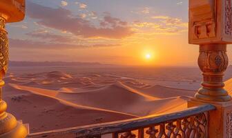 A vast desert landscape with sand dunes and a setting sun, viewed from a balcony with Arabian architectural elements photo
