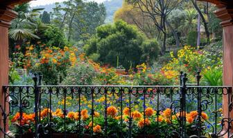 A vibrant garden full of blooming flowers, seen from a balcony with wrought iron railings photo