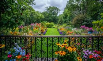 A vibrant garden full of blooming flowers, seen from a balcony with wrought iron railings photo