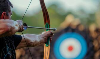 An archer's body aiming a bow, with the target in the background photo