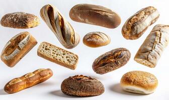Different types of bread such as baguette, ciabatta, and sourdough floating in mid-air with a white background photo