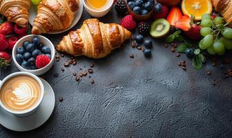 A delicious breakfast spread with coffee, croissants, and fruit photo