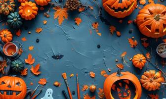 A flat lay featuring Halloween crafts like carved pumpkins, ghost cutouts, and paintbrushes, with an open area for text photo