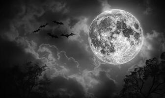 A full moon with eerie clouds and flying bats, with open space at the bottom for text photo