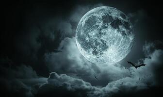 A full moon with eerie clouds and flying bats, with open space at the bottom for text photo