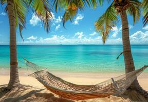 A pristine sandy beach with crystal-clear turquoise waters and a hammock between two palm trees photo