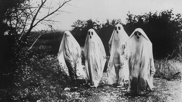 A vintage black-and-white Halloween photo with ghostly figures, leaving plenty of space on the right for a message