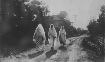 A vintage black-and-white Halloween photo with ghostly figures, leaving plenty of space on the right for a message