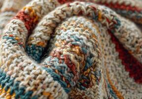 A close up of a knitted wool blanket, revealing the complex stitching and fiber details photo