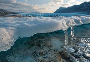 A close up of a melting glacier with clear water dripping down its surface photo