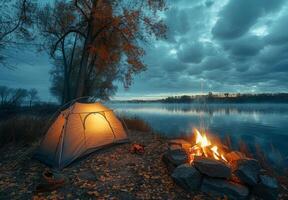Camping tent on the shore of a lake at dusk photo