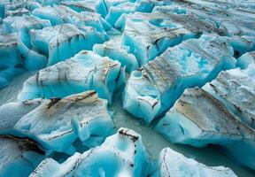 A close up of a glacier with blue ice photo