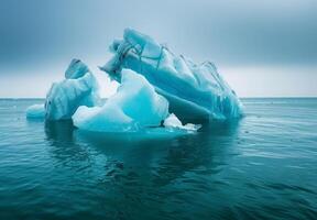 Iceberg in the ocean with blue water photo
