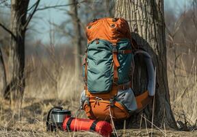 A backpack and a coffee cup sitting on the ground photo