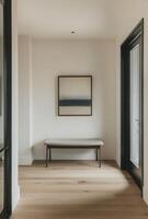 Minimalist entryway with clean lines, a simple bench, and a single piece of artwork on the wall photo