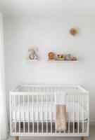 Minimalist nursery with clean white walls, a simple crib, and a small shelf with toys neatly arranged photo